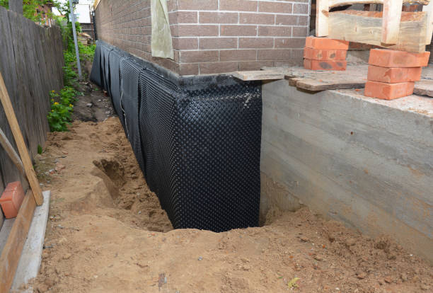Happy homeowners after waterproofing job in Durand